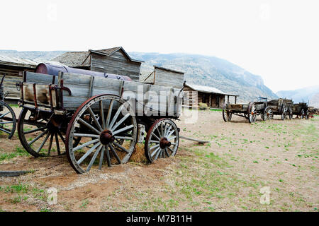 Wagons and abandoned houses in a ghost town, Old Trail Town, Cody, Wyoming, USA Stock Photo