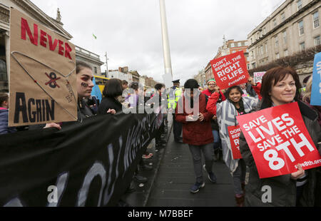 Dublin, Ireland. 10th March 2018. Pro-choice campaigners who want to ‘Repeal the Eighth’ amendment hold a silent protest as those who want to ‘Save the Eighth’ pass by on O’connell Street in Dublin City centre. The eighth amendment to the Irish constitution equates, in law, the right to life of the unborn with the right to life of the mother. Ireland is due to hold a referendum on abortion this coming May.  Credit : Laura Hutton/Alamy Live News.
