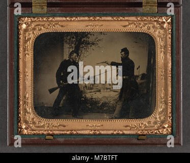 Two unidentified soldiers in Union uniforms posing with bayoneted Springfield Model 1861 rifled musket with attached bayonet, knife, and Colt Model 1851 Navy revolver in front of painted LCCN2010650759 Stock Photo