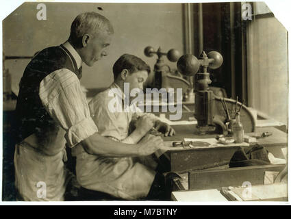 14-year old Fred cutting dies for a new job. Embossing shop of Harry C. Taylor. 61 Court Street. LOC nclc.05616 Stock Photo