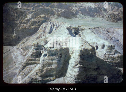 This image shows the Dead Sea Scrolls and the caves at Qumran, where ...
