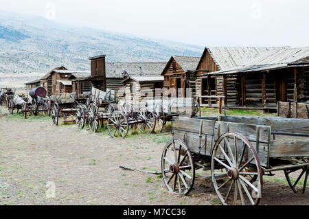 Wagons and abandoned houses in a ghost town, Old Trail Town, Cody, Wyoming, USA Stock Photo