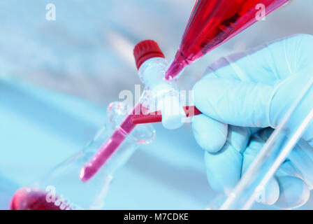 Close-up of a person's hand adjusting the stopcock of a separating funnel Stock Photo