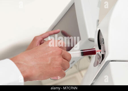 Lab technician testing blood samples in a laboratory Stock Photo
