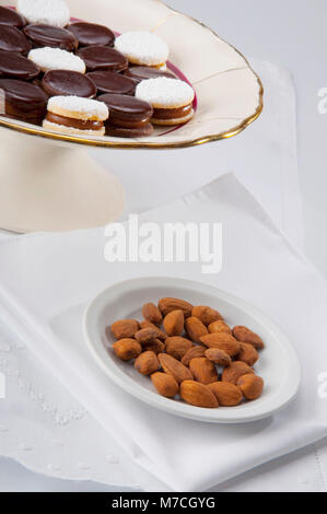 Chocolate cream cookies served with almonds Stock Photo