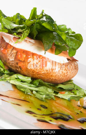 Close-up of baked jacket potatoes topped with sour cream and spinach Stock Photo