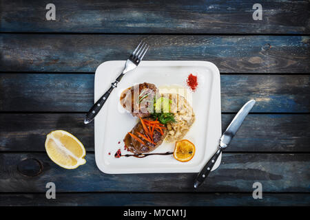 Beef cutlets with vegetables and meat sauce. Stock Photo