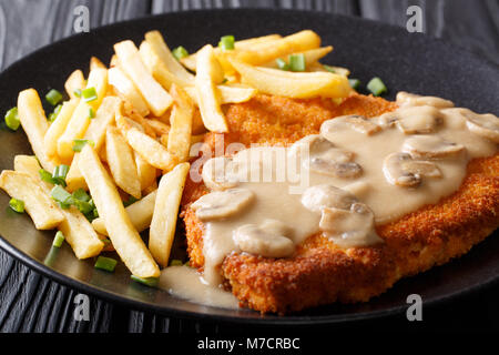 delicious Wiener Hunter schnitzel with sauce and french fries close-up on a plate. horizontal Stock Photo