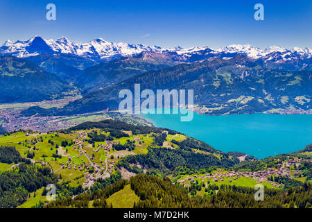 Aerial view of Lake Thun and Bernese Alps including Jungfrau, Eiger and Monch peaks from the top of Niederhorn in summer, Canton of Bern, Switzerland. Stock Photo