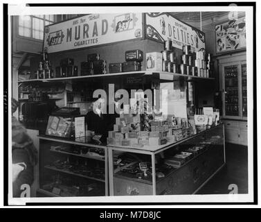 The interior of People's Drug Store in Washington, D.C., showing employees behind the counter with a display of smoking products, including cigars and tobacco. Stock Photo