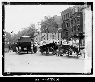 A scene of lunch vendors operating outside the Treasury Annex, offering a variety of food options to passersby in a busy urban setting. Stock Photo