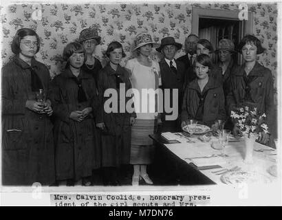 Mrs. Calvin Coolidge and Mrs. Herbert Hoover with some Girl Scouts at the Girl Scout 'Little House,' where they demonstrated for Mrs. Coolidge the performances of home making. LCCN2002697232 Stock Photo