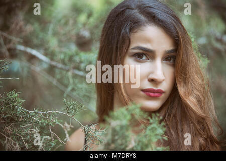 Serious young woman staring outdoors Stock Photo