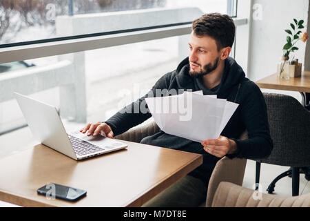 Concentrated Young Bearded Businessman Wearing Black Tshirt Working Laptop Urban Cafe Stock Photo