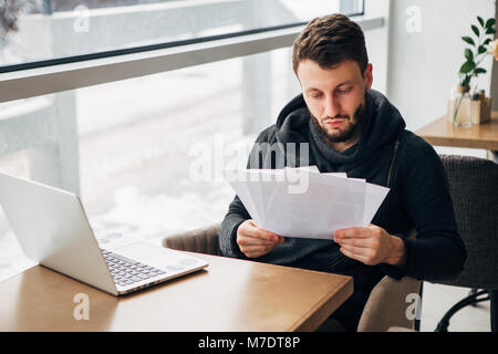 Concentrated Young Bearded Businessman Wearing Black Tshirt Working Laptop Urban Cafe Stock Photo