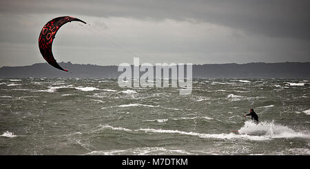 Kite surfer riding stormy seas off the North Wales coast Stock Photo