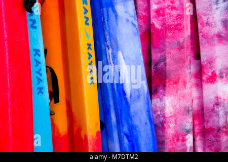 Row of colourful sea kayaks at Llangranog on the coast of Wales Stock Photo