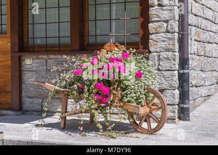 Traditional and decorative floral arrangement in a mountain setting in the Alps Stock Photo