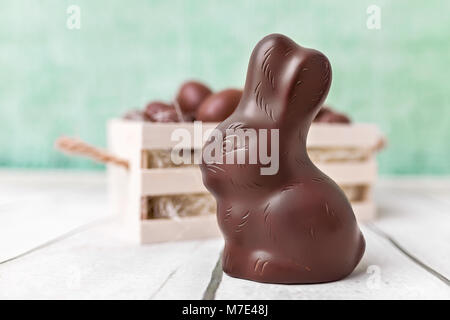 Delicious chocolate Easter bunny and eggs in a basket Stock Photo