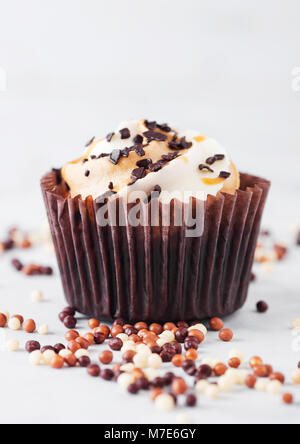 Fresh toffee cupcake muffin with caramel and chocolate on marble background Stock Photo