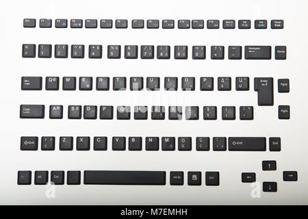 Loose alphanumeric covers for the keys on a computer keyboard on a white or light silver background viewed from overhead centered in the screen with s Stock Photo