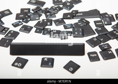 Composed of loose key covers from a computer with the empty space key in a close up low angle conceptual view Stock Photo