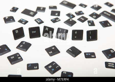 Computer keyboard composed of loose key covers from a computer with the six keys in a close up high angle conceptual view Stock Photo