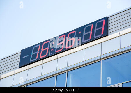 Photo of electronic clock on building in afternoon Stock Photo