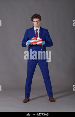 Angry man wearing in boxing gloves ready for fight Stock Photo