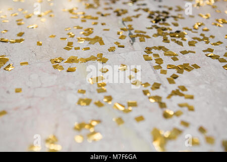 the gold confetti on the floor. background Stock Photo