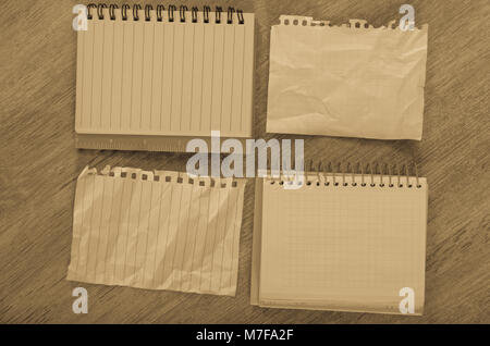 Crumpled empty pages and notebook lying on wooden surface Stock Photo