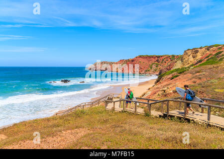 PRAIA DO AMADO BEACH, PORTUGAL - MAY 15, 2015: Surfers with boards walking to beach on sunny beautiful day. Water sports are popular activity in this  Stock Photo