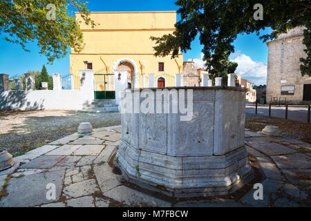 RHODES, GREECE - MAY 04: Fountain at Arionos square in the Old Town on May 04, 2016 in Rhodes city, Greece. Pyramidal shape Sultan Mustafa Mosque with Stock Photo