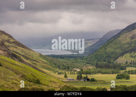 Braemore, Scotland - June 8, 2012: West of Corrieshalloch Gorge along A832 from height look upon Loch Broom under cloudy cloudscape. Green forested mo Stock Photo