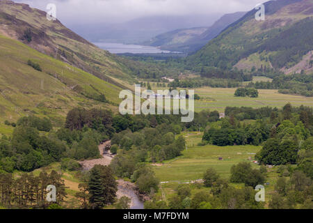 Braemore, Scotland - June 8, 2012: West of Corrieshalloch Gorge along A832 from height look upon river and Loch Broom under cloudy cloudscape. Green f Stock Photo