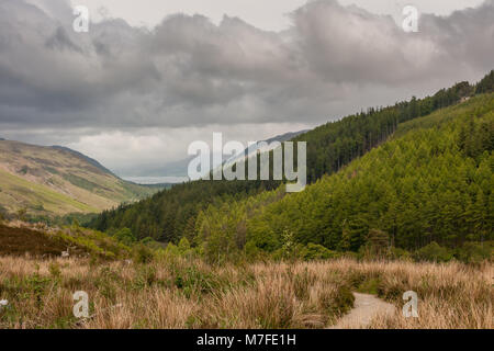 Braemore, Scotland - June 8, 2012: West of Corrieshalloch Gorge along A832 from height look upon Loch Broom under monumental cloudscape. Green foreste Stock Photo