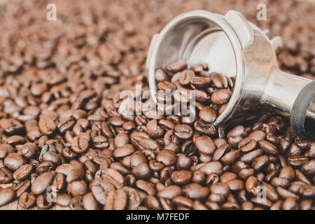 Metal coffee maker and a pattern of coffee beans in the shape of a circle  on a gray background with Stock Photo by Artjazz