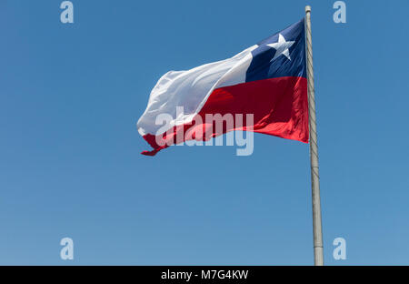 Flag of Chile developing against a clear blue sky. Patriotic symbol of Chile, South America. Stock Photo