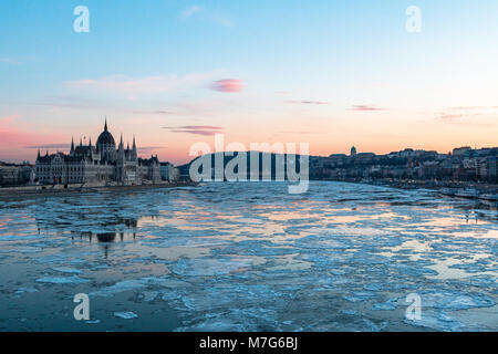 The Hungarian Parliament building and Royal Palace with ice floes on the Danube in Budapest in winter Stock Photo