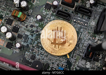 Bitcoin on circuit board. Cryptocurrency bit-coins and computer