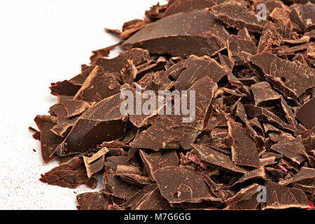 Chocolate pieces stacked on white background. View in close up Stock Photo