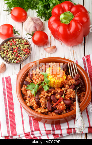 Homemade stewed spicy meat with beans, corn and spices. Chili con carne. A dish of Mexican cuisine. Selective focus Stock Photo