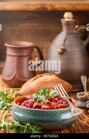 Red beans with tomatoes, garlic, spices and parsley. Lobio. Stewed legumes. Selective focus Stock Photo