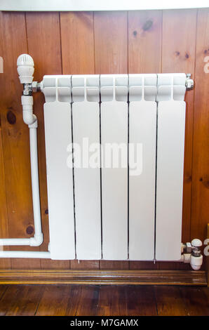 Hand regulates temperature in radiator Stock Photo