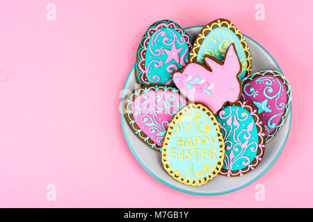 Easter homemade baked gingerbread cookies in the form of eggs with different pattern of icing on plate Stock Photo