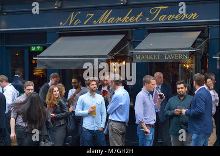 Business casual dressed employees enjoying after work drinks at No7 Market Tavern, London UK Stock Photo