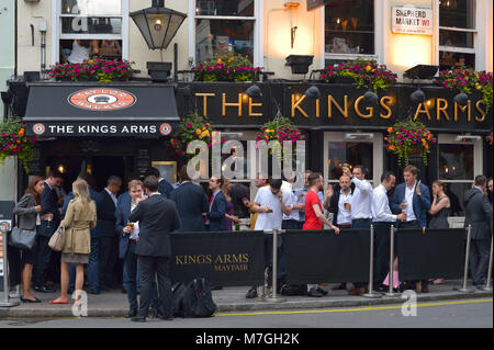 Formally dressed employees enjoying after work drinks at The Kings Arms, London UK Stock Photo