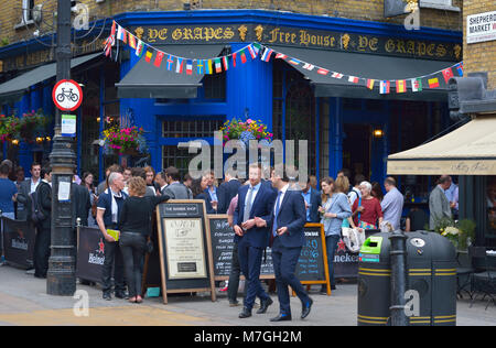 Formally dressed employees enjoying after work drinks, London UK Stock Photo