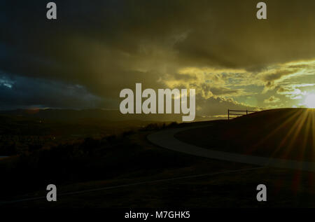 Sunset sky with silhouettes of people in the foreground. Stock Photo
