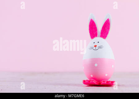 One funny easter bunnies on pink background with copy space Stock Photo